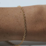 Gold chain bracelet on wrist