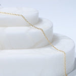 Gold chain necklace on white display