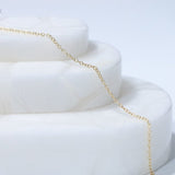 Gold chain necklace on white display