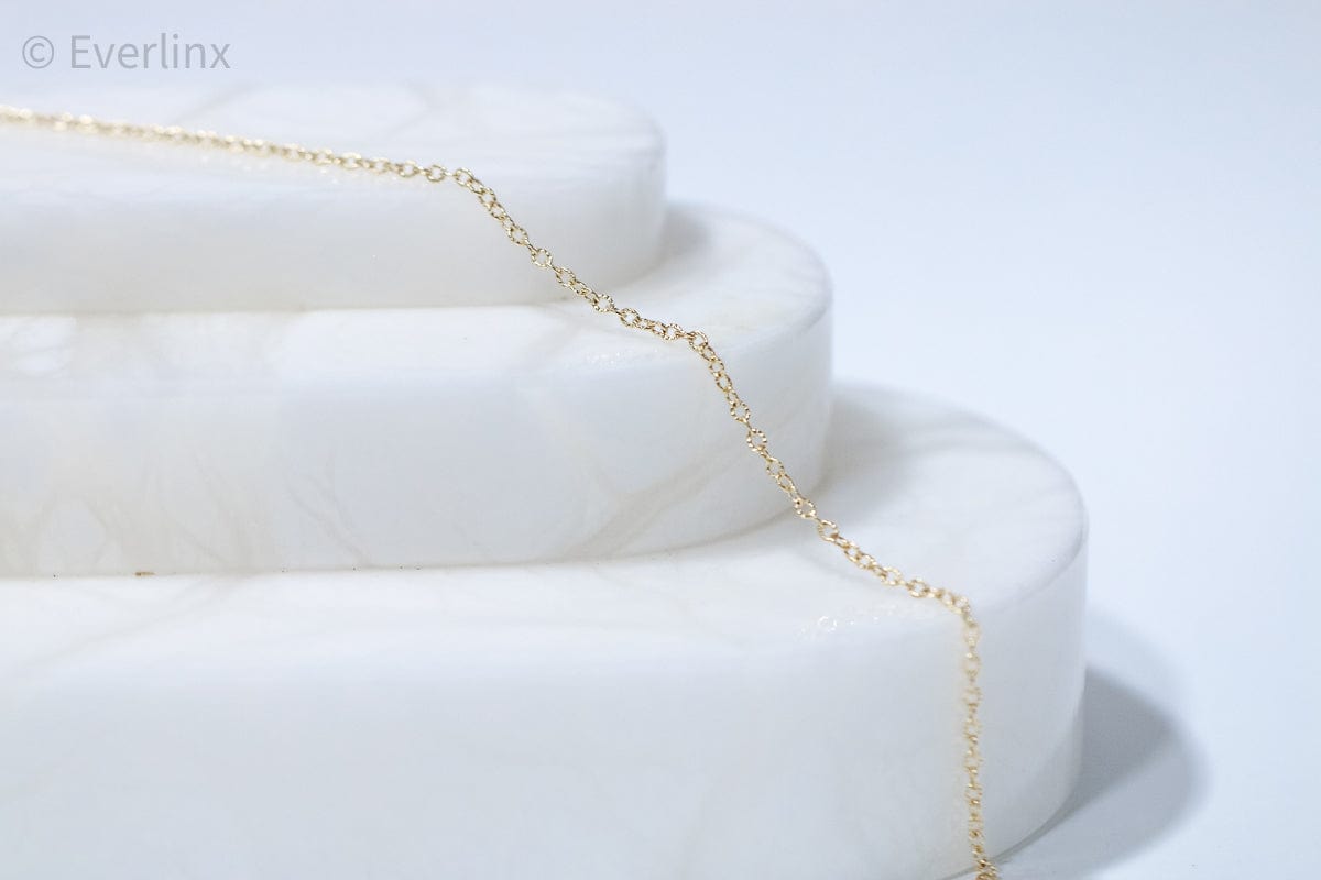 Gold chain necklace on white display